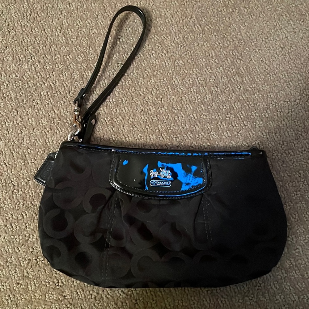 black Coach wristlet with red interiors